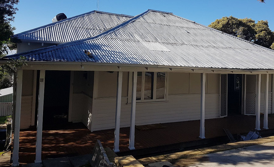 Elevation of older re-roofed house with verandurah