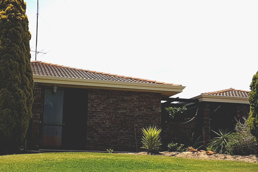 Split image of old house elevation, showing old tile roof before and new Colorbond roof after